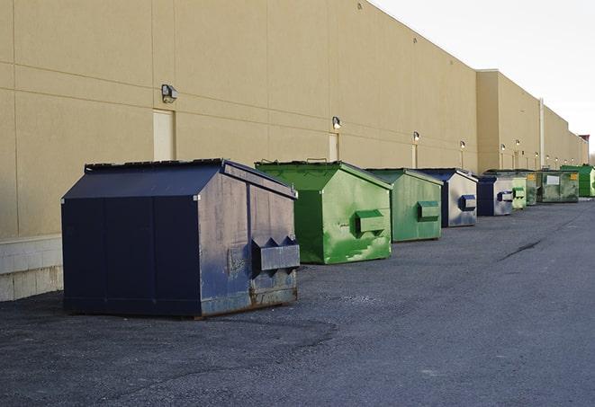 a stack of yellow construction dumpsters on a job site in Colfax